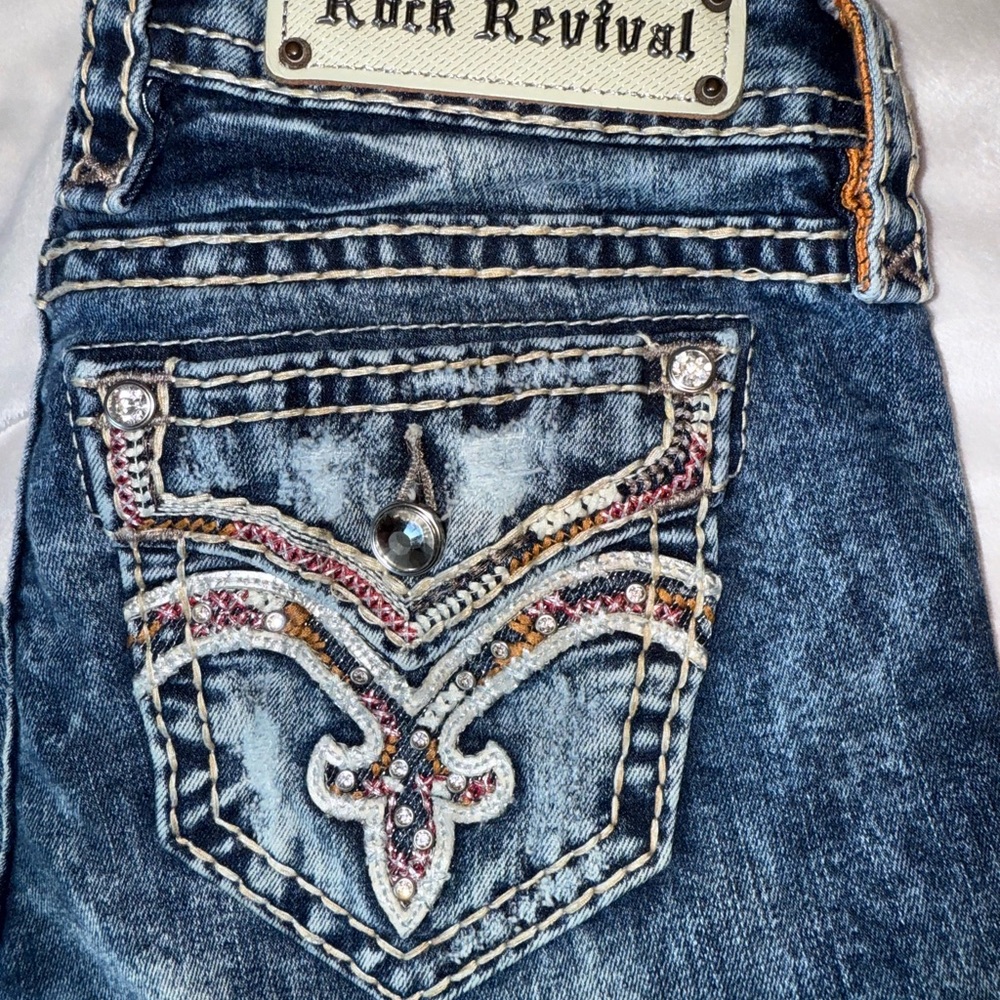 Rock Revival Distressed Blue Jeans with Embellished Pockets